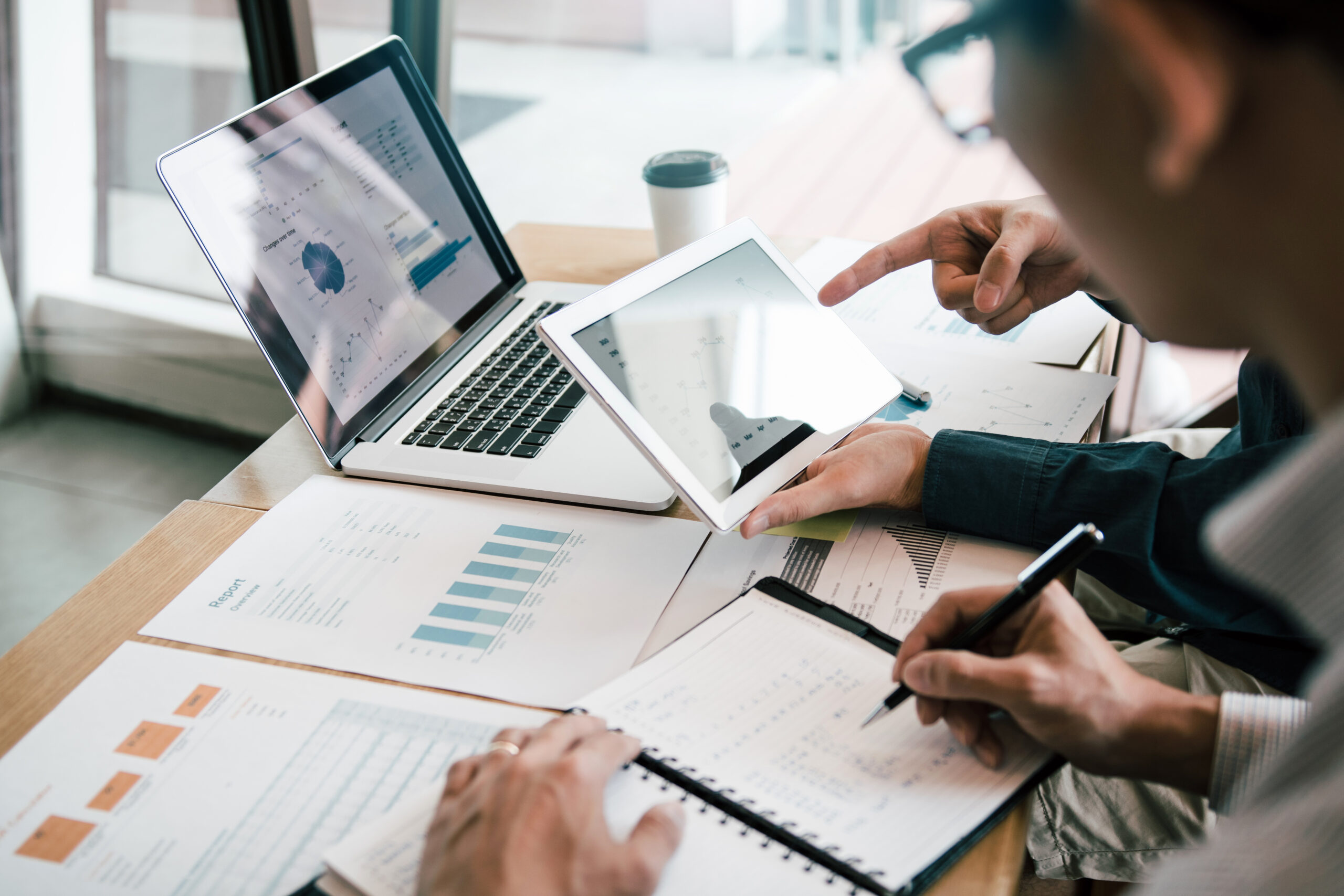 Business partnership coworkers using a tablet to analysis graph